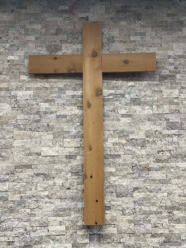Wooden cross hanging on wall