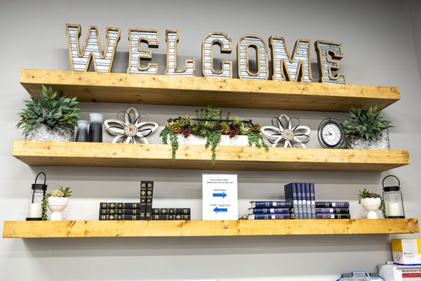 Welcome sign and wooden shelves